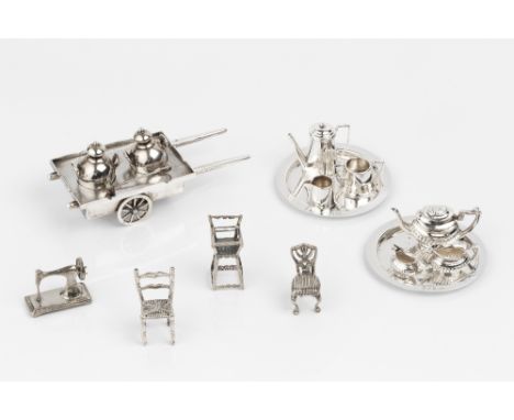 TWO SILVER THREE PIECE MINIATURE TEA SERVICES, each on circular tray, by John Rose, Birmingham 1977, 7cm diameter; together w