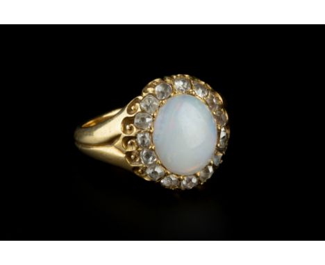 AN OPAL AND DIAMOND CLUSTER RING, the oval cabochon opal bordered by a row of cushion-shaped old-cut diamonds, above a scroll