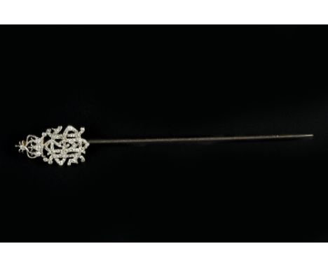 A DIAMOND SET STICK PIN, the terminal modelled as a monogram surmounted by a coronet, set throughout with single, rose and la