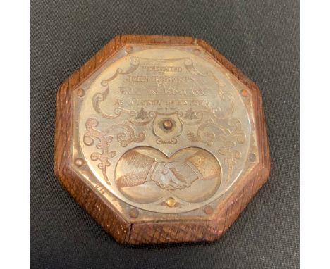 A 19th century oak Tam O'shanter snuff box, the octagonal body with silver plated revolving front, embossed with clasped hand