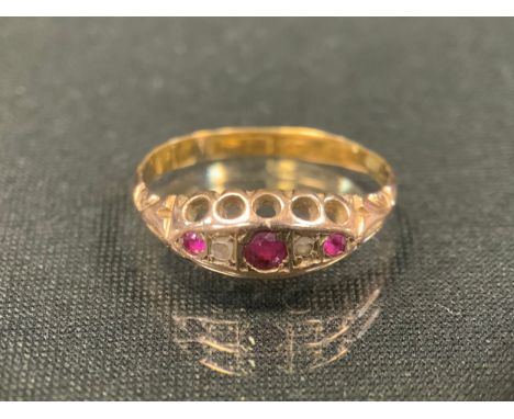 A 19th century diamond and ruby ring, with three graduated pink red rubies divided by rose cut diamond accents, indistinctly 