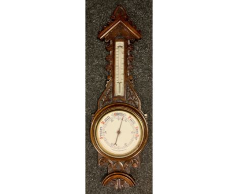 A carved oak barometer thermometer, floral carved case, cream aneroid scale, 89cm long 