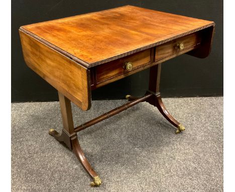 A George III mahogany sofa table, rounded rectangular over-sailing top with reeded edge, pair of short drawers to frieze, tur