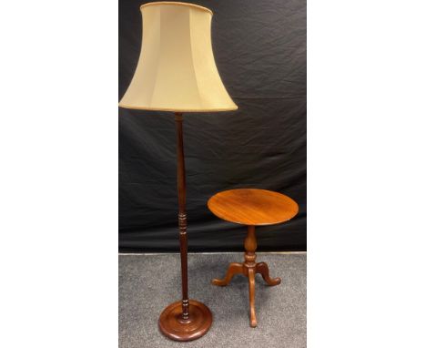 A 19th century mahogany tripod table, 68cm high x 55.5cm diameter;  a mid 20th century mahogany standard lamp, 170cm high, (2