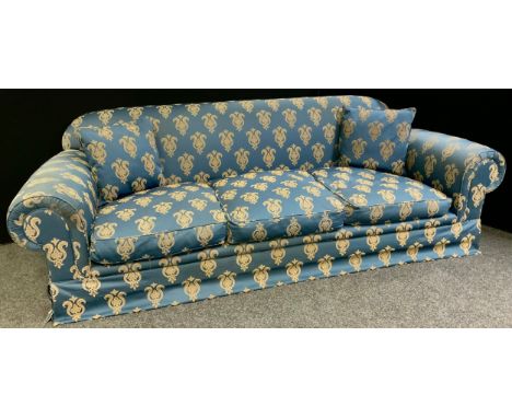 A 20th century roll arm three seater sofa, upholstered in blue and gold, feather and down cushions, 80cm high, 258cm wide, 10