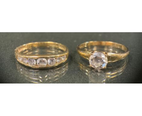 A cubic zirconia solitaire ring, 14 ct gold shank, size U, stamped 585 DQCZ, 2.8g gross;  another seven stone, stamped 585 DQ