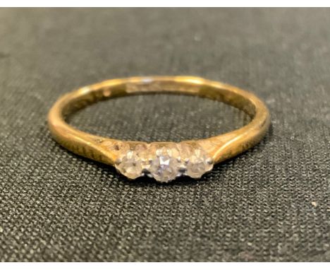 A diamond three stone ring, total estimated diamond weight approx 0.10ct, 18ct gold shank, size P, 2.2g gross 