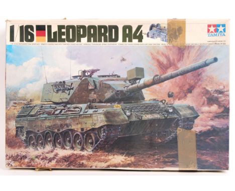 A rare vintage Tamiya 1:16 scale Leopard A4 Tank model kit. Within the original box. Appears largely made, with inner gearing