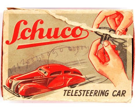 A charming pre-war c1930's German Schuco made ' Telesteering Car ' tinplate clockwork car. Appears complete, with all wooden 