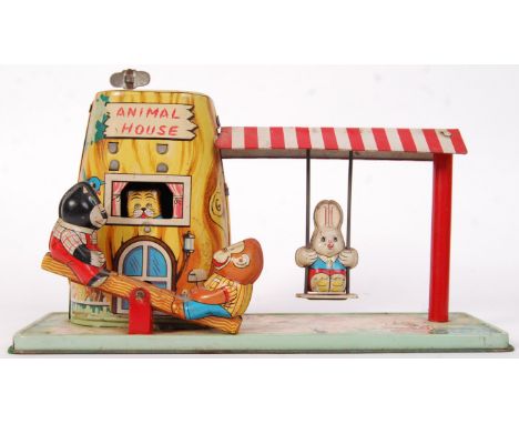 An original vintage 1950's Japanese clockwork tinplate Animal House with play garden. Measures approx 22cm wide. 
