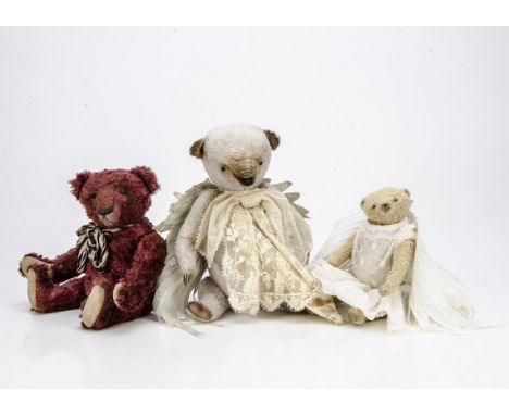 Three artist teddy bears, of artificial silk plush, one grey with swivel head, jointed limbs, lace bow and angel wings --11in