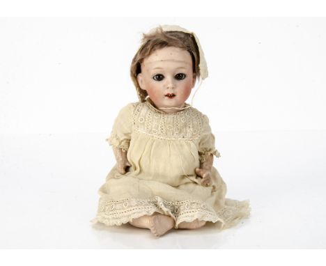 A Gebruder Heubach 8192 character baby,  with brown sleeping eyes, brown mohair wig, bent-limbed composition body, cream crep