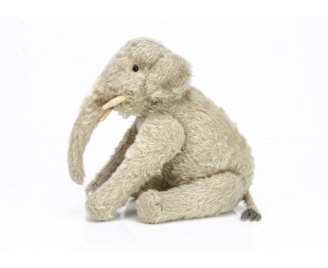 A rare and fine  Steiff jointed elephant circa 1908, with grey mohair, black boot button eyes, white felt tusks, swivel head,