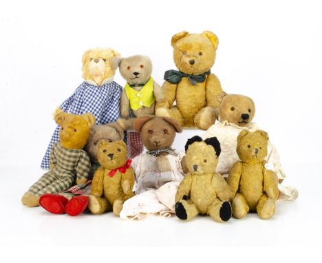 Various teddy bears, a worn jointed 1930s teddy bear in dress --15in. (38cm.) high; a pin-jointed short mohair teddy bear in 