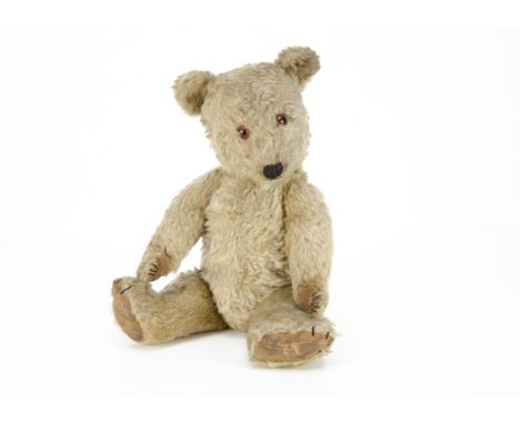 A post-war Chiltern Hugmee teddy bear,  with blonde mohair, orange and black glass eyes, black stitched nose, mouth and claws