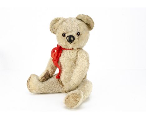 A post-war Chad Valley teddy bear, with blonde mohair, orange and black glass eyes, muzzle with black stitched nose and mouth