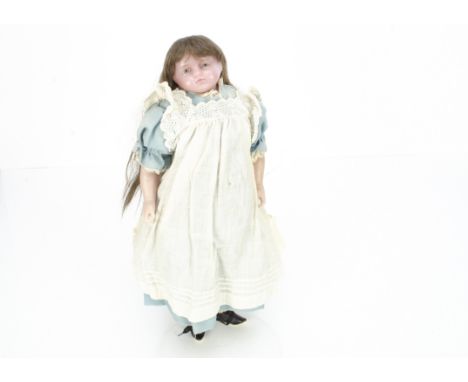 An English poured pale wax shoulder-head doll with  H W Morrell ink stamp, probably Pierotti with inset blue glass eyes, inse