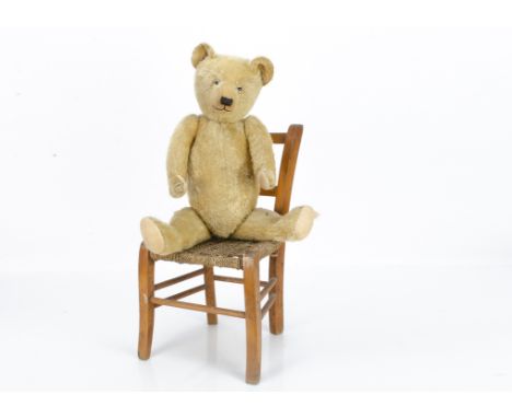 A Chiltern teddy bear late 1920s, with light golden mohair, clear and black glass eyes, pronounced muzzle, black stitched nos