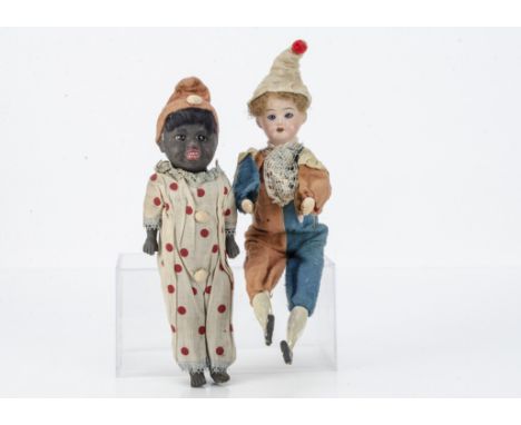 A German clown toy, with bisque head, wooden limbs, original clown costume, when pressed he clashes his cymbals --12 ½in. (32