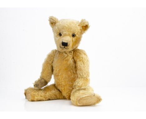 A 1930s Chiltern Hugmee teddy bear,  with golden mohair, clear and black glass eyes with brown painted back, pronounced clipp