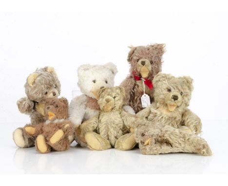 Four post-war Steiff Zotty teddy bears, two brown frosted with buttons (both with balding areas to backs), a white dralon exa