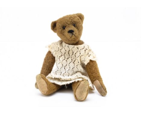 An unusual early German teddy bear circa 1910, similar to Bing with unusual brown wool plush, black boot button eyes, pronoun