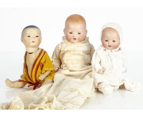 Three small German bisque headed baby dolls,  an Oriental with dark sleeping eyes, closed mouth, black painted hair, bent-lim