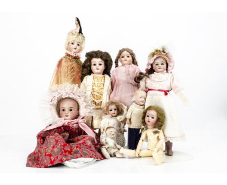 Eight various bisque headed dolls,  one marked 2000 with jointed composition body --14in. (35.5cm.) high (crack down back of 