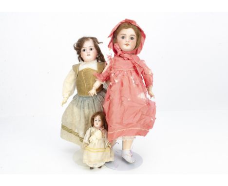 Three French bisque headed dolls,  a S.F.B.J. 301 child doll with blue sleeping eyes, brown mohair wig, jointed papier-mâché 