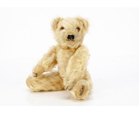 A small 1930s Merrythought teddy bear,  with light golden mohair, orange and black glass eyes, pronounced clipped muzzle, bla