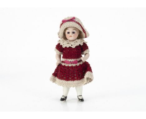 An all-bisque dolls' house doll,  with dark glass eyes, blonde mohair wig, fixed neck, jointed limbs with painted socks and h