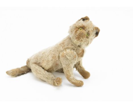 An early Steiff six-way jointed cat circa 1910, with white mohair, pale green and black glass eyes, pink stitched nose and mo