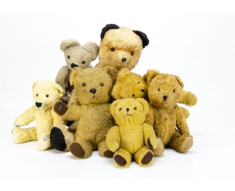 Seven post-war teddy bears, a large cotton plush Sooty type teddy bear with swivel head and jointed limbs --24in. (61cm.) hig