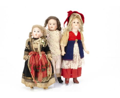 Three small bisque headed dolls,  one with dark glass eyes, closed mouth, blonde mohair wig, composition straight legged, ori