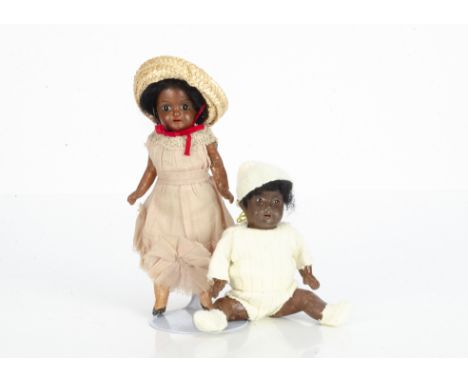 Two small German black dolls,  a black bisque headed girl marked 812 with fixed dark glass eyes, black mohair wig, compositio