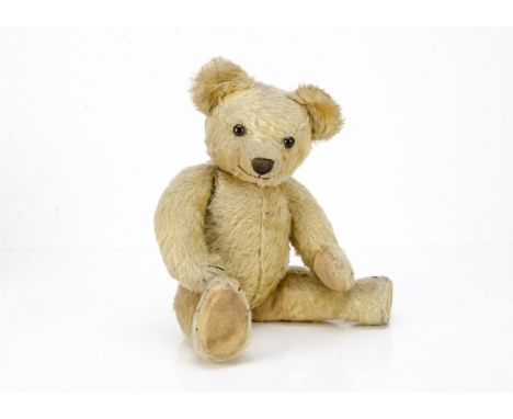 A 1920s Chad Valley teddy bear, with golden mohair, replaced brown and black glass eyes, pronounced clipped muzzle, black sti