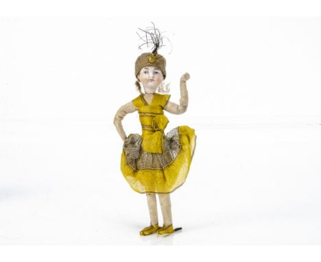 A German bisque headed Flapper Christmas cracker doll, with blue painted eyes, closed mouth, wisps of brown mohair, wired bod