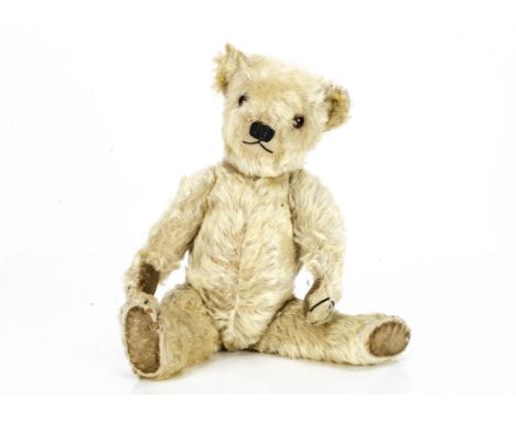 A 1930s Chiltern white mohair teddy bear,  with orange and black glass eyes, black stitched nose, mouth and claws, swivel hea