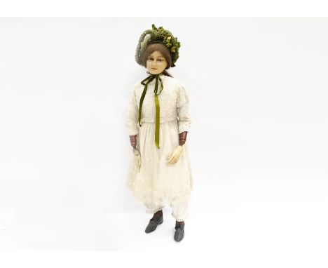 A rare late 19th century poured wax headed shop mannequin,  of a girl with light brown inset glass eyes, head turned to the r