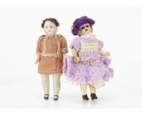 Two dolls' house dolls,  a German bisque headed with dark glass eyes, brown mohair wig, jointed composition body and knitted 