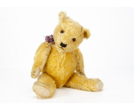 A 1930s Chiltern-type teddy bear, with golden mohair, orange and black glass eyes, pronounced muzzle, black stitched nose, mo