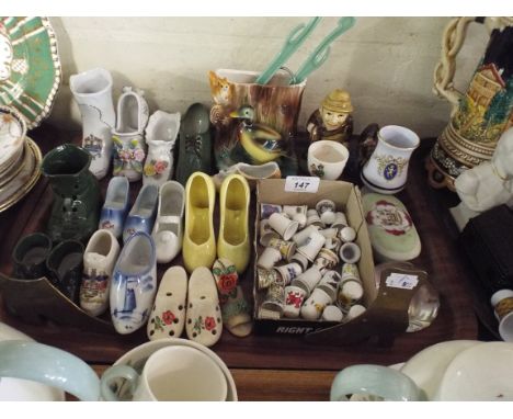 A Tray containing Ceramic Shoe Ornaments, Thimbles etc