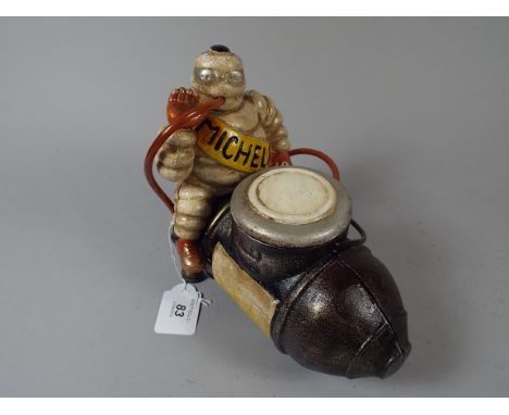 A Cast Metal Model of Michelin Man Astride Compressor (item 45, plus VAT)