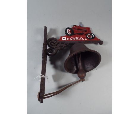 A Cast Metal Wall Hanging Door Bell with Tractor Motif (item 38, plus VAT)