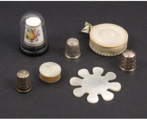 A mixed lot – sewing comprising an engraved Chinese snowflake silk winder, 5cm, a mother of pearl disc form pin cushion, 4cm 