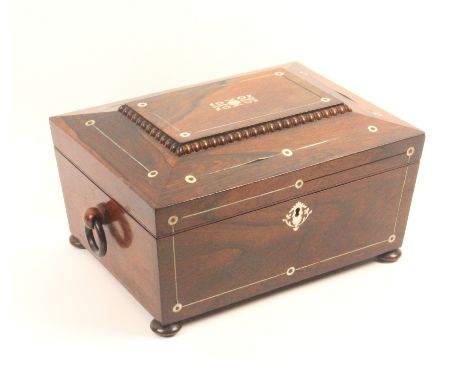 A rosewood sarcophagal form sewing box, circa 1860, with pewter line and mother of pearl decoration, on bun feet and with rin
