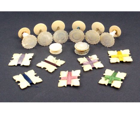 A set of six mother of pearl top reels together with disc form waxer and pin cushion, the reels 3.5cm high 2.8cm dia, and a s