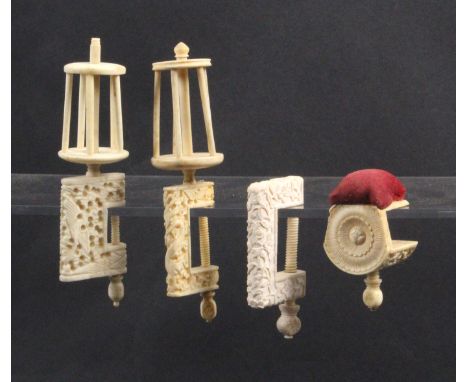 Four 19th Century Chinese ivory sewing clamps, all variously carved comprising a pin cushion example, two with birdcage reels