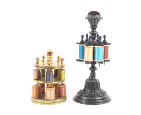 Two mid 19th Century metal reel stands comprising a cast iron example with circular berried leaf base below two pierced tiers
