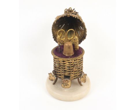 A French gilt metal novelty etui in the form of a beehive, circa 1870, on circular alabaster base, the wicker hive with leave